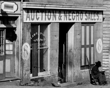 United States Colored Troop enlisted African-American soldier reading at 8 Whitehall Street, Atlanta slave auction house, Fall 1864- 'Auction & Negro Sales,' Whitehall Street LOC cwpb.03351 (cropped) photo