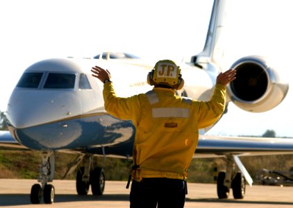 United States Navy aircraft handler directs C-37 Gulfstream V takeoff preparations at Souda Bay 021031-N-0780F-003
