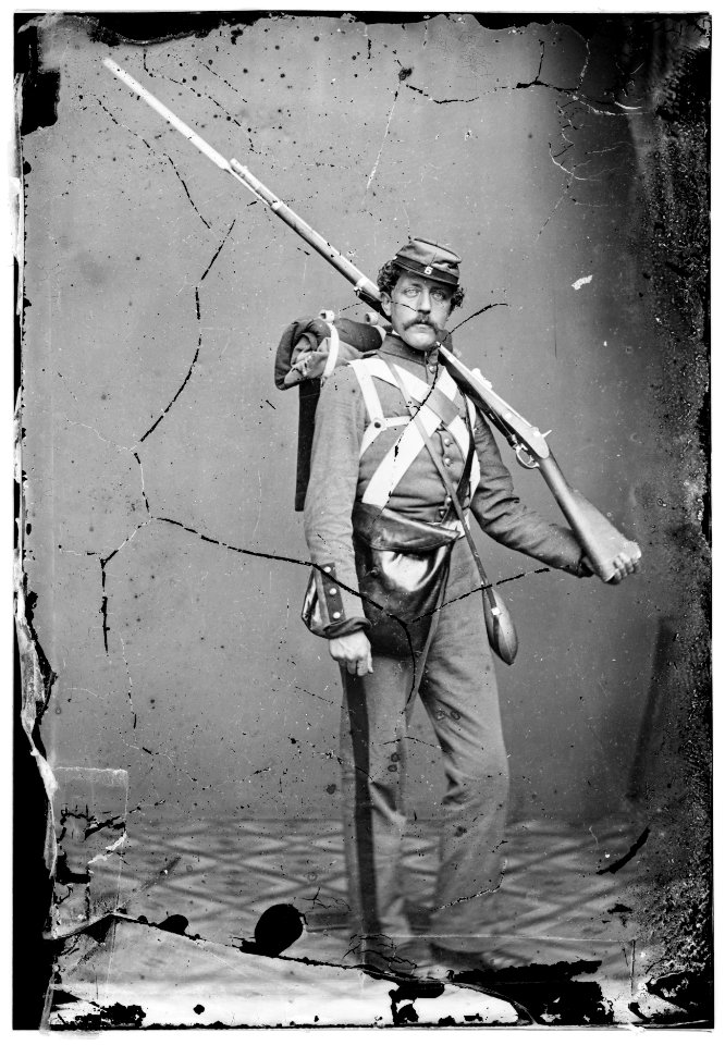 Unknown location. Unidentified Union volunteer with shouldered rifle and bayonet in photographer's studio LOC cwpb.04763