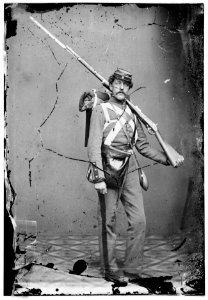 Unknown location. Unidentified Union volunteer with shouldered rifle and bayonet in photographer's studio LOC cwpb.04763