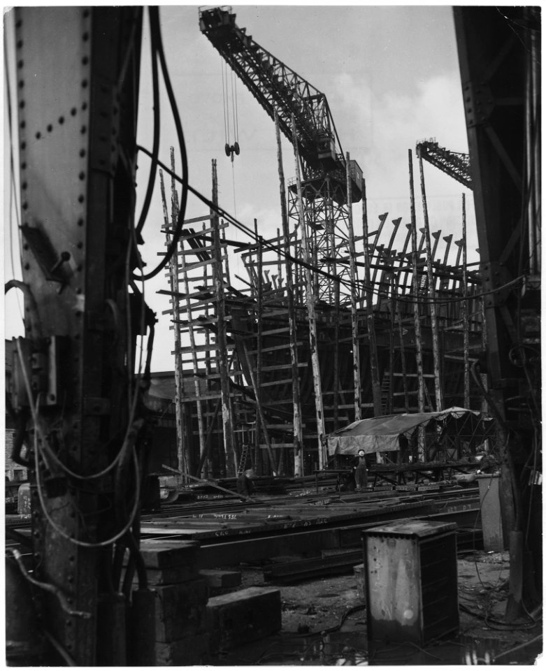 United Kingdom. Clydebank, Scotland. Still a shapless frame work of steel scaffolding, this 28,000 ton oil tanker... - NARA - 541770