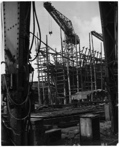 United Kingdom. Clydebank, Scotland. Still a shapless frame work of steel scaffolding, this 28,000 ton oil tanker... - NARA - 541770 photo