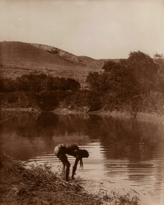 Untitled (Native American bending at riverbank) photo