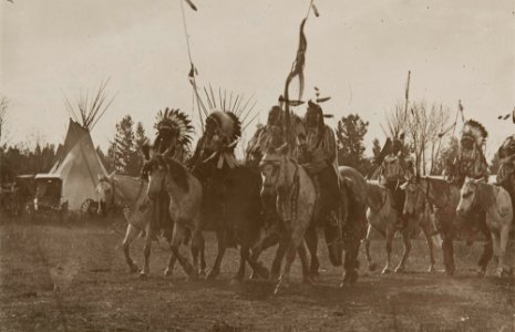 Untitled (Native Americans wearing headdresses on horseback)