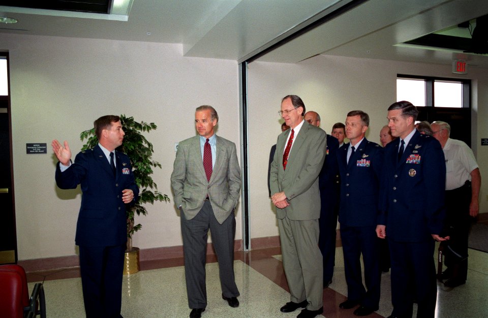 US Air Force Captain Andrew Molner gives a tour to Joe Biden, Mike Castle, Felix Greider, and William Wellser