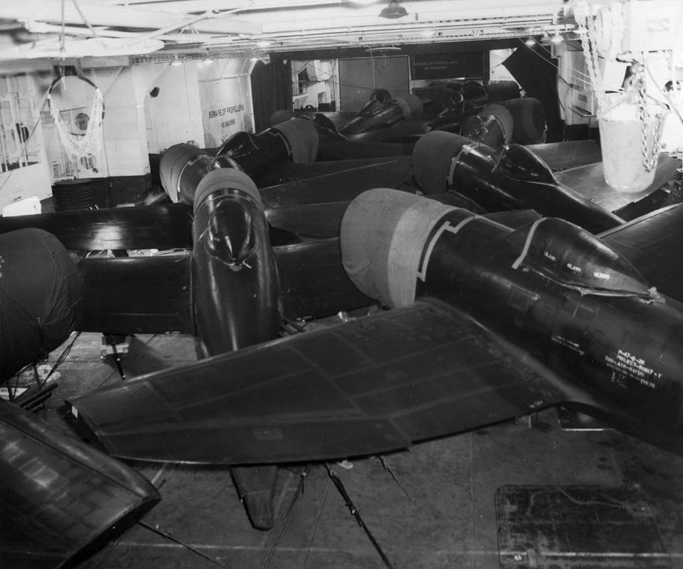 US Army Air Force P-47D Thunderbolt fighters stored inside the hangar bay of USS Shamrock Bay (CVE-84) in July 1944