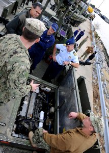 US Coast Guard liaison officers during a visit to Navy Expeditionary Combat Command 131115-N-MD211-026