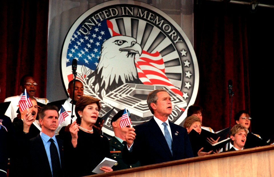 US Navy 011011-D-9880W-223 President George W. Bush and first lady Laura Bush wave the flag and sing