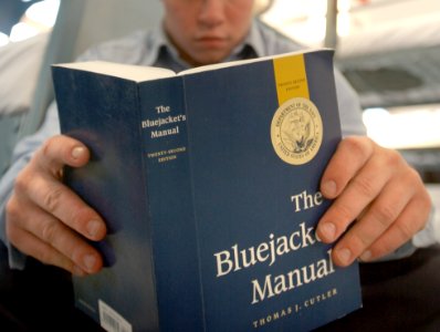 US Navy 020329-N-3995K-108 Recruit studies the Bluejacket's Manual