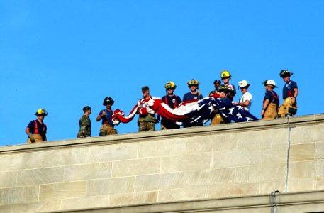 US Navy 010912-N-3235P-004 Military, rescue workers, and firefighters prepare to unfurl flag over Pentagon