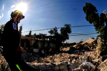 US Navy 011020-N-6006S-083 A Member of the Virginia Task Force 1 Urban Search and Rescue Team surveys the destruction caused by the recent earthquake in Port-au-Prince