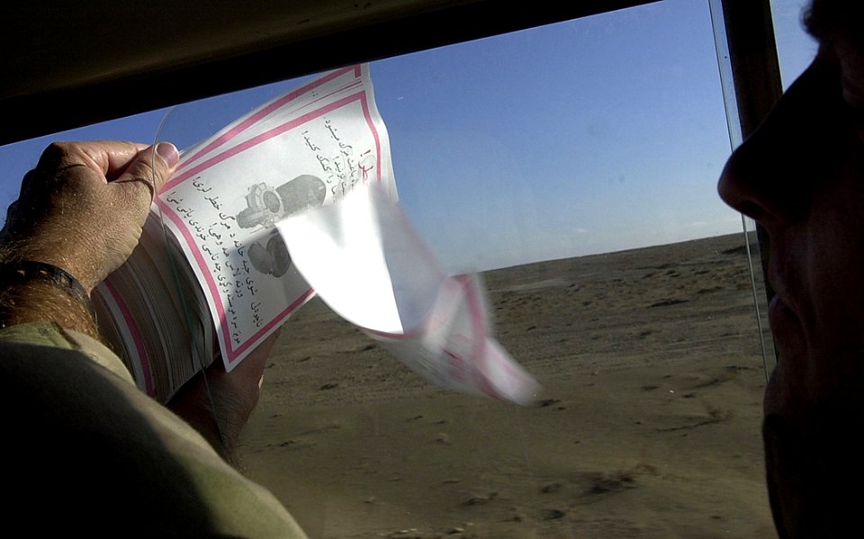 US Navy 011218-F-3961R-002 USA Civil Affairs soldiers distribute leaflets warning local Afghan people to stay clear of unexploded weapons