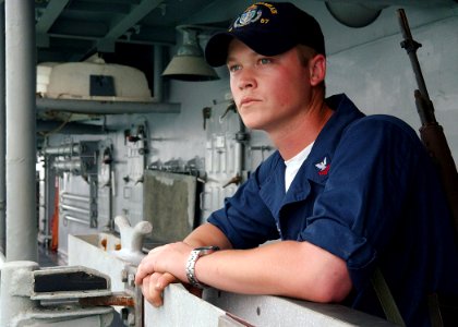 US Navy 020610-N-4776G-056 Fire Controlman 2nd Class Aaron L. Clupper from Peru, Ind., stands watch, searching the water at the Changi Naval Base for swimmers or other potential dangers to USS Lake Champlain (CG 57)