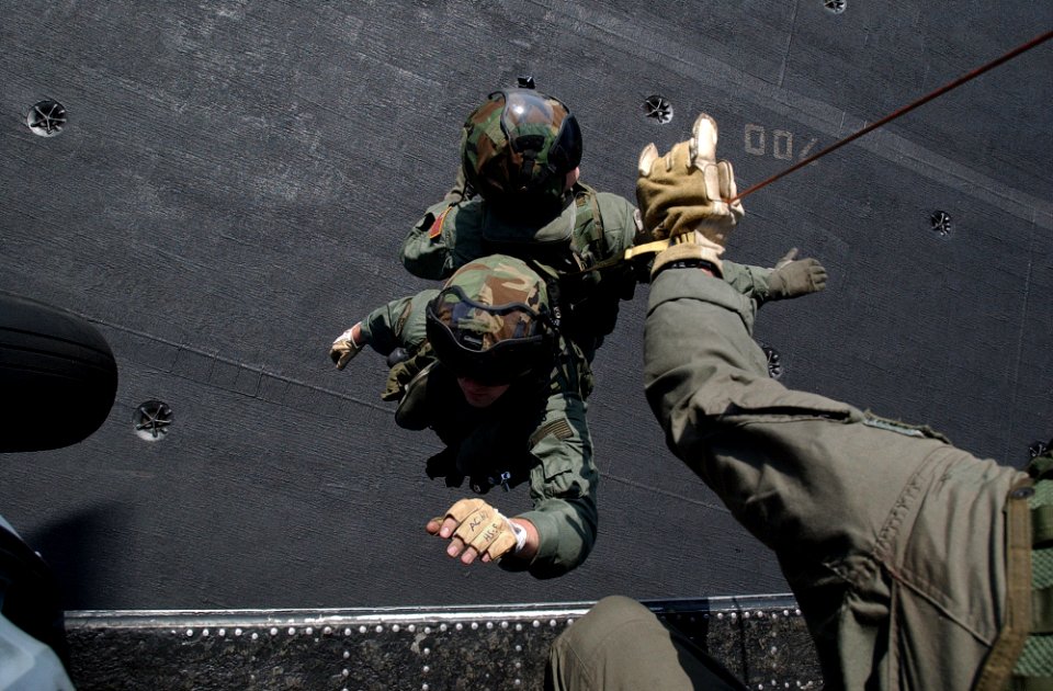 US Navy 020725-N-6492H-555 Aircrewmen are lifted from the flight deck of USS John F. Kennedy by an HH-60H Seahawk helicopter