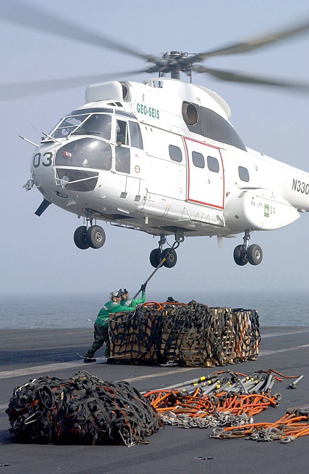 US Navy 020729-N-2329T-002 Sailors attach a Cargo Net to a Puma Helicopter