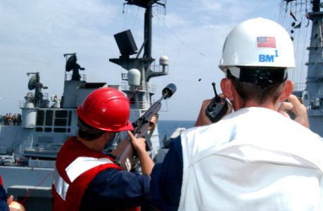 US Navy 020508-N-6492H-594 Sailor fires a shot-line to ship along side during replenishment as sea