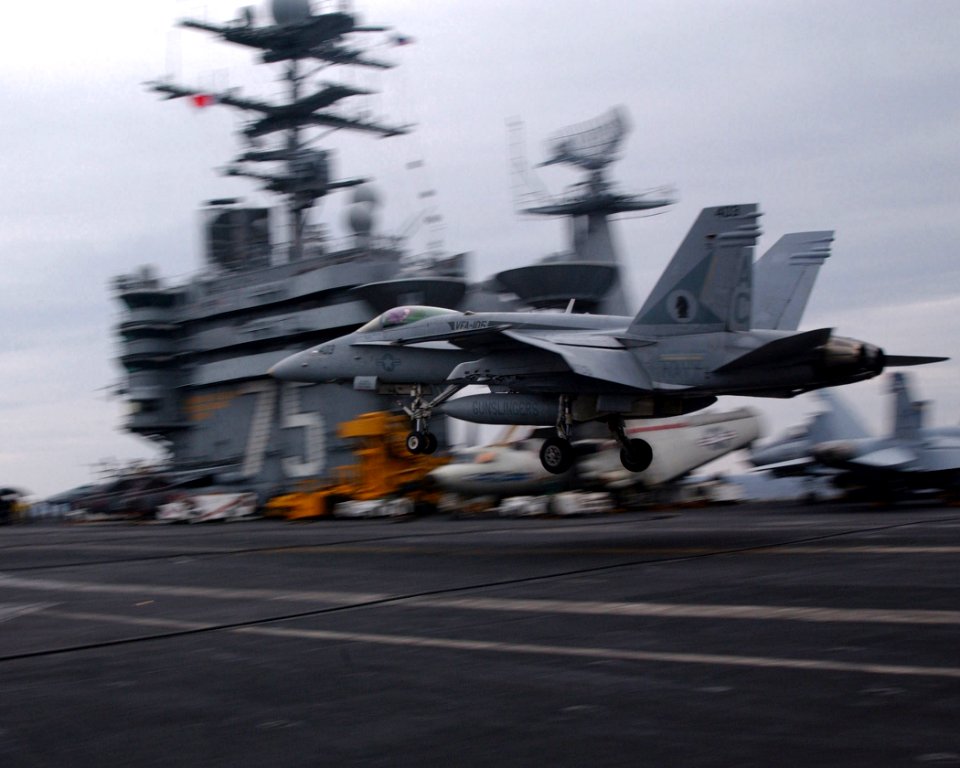 US Navy 021025-N-4953E-001 An F-A 18 'Hornet' assigned to the 'Gunslingers' of Strike Fighter Squadron One Zero Five (VFA-105), performs a 'touch and go' on the ship's flight deck