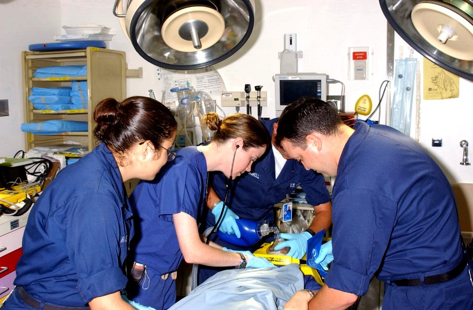 US Navy 021029-N-0000W-001 A U.S. Navy ER General Medical Officer, provides trauma training to a team of Emergency Medical Technicians