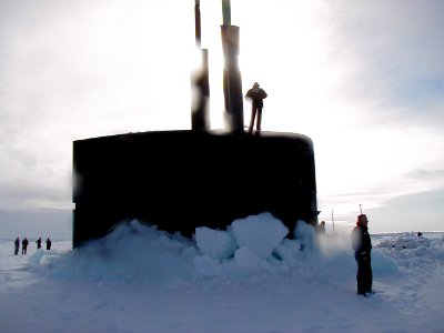 US Navy 010605-N-0000X-001 Sailors stationed aboard the Los Angeles-class fast attack submarine USS Scranton (SSN 756) are silhouetted by the Arctic sun