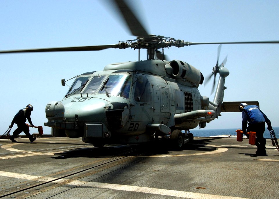 US Navy 020626-N-4374S-015 At sea aboard USS Cushing (DD 985) Jun. 26, 2002 - Sailors assigned to the chock and chain crew prepare to park an SH-60