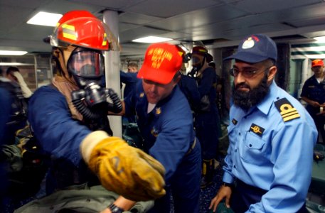 US Navy 020924-N-4309A-032 Crewmembers aboard Rueben James give instructions on how a general quarters drill works to a member of the Pakistani Navy