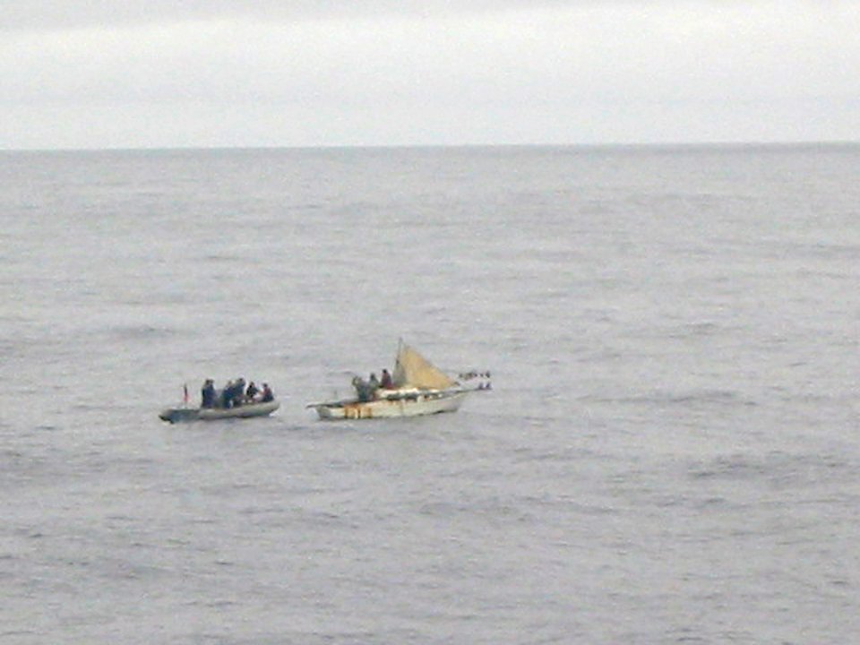 US Navy 020917-N-0000X-012 U.S. Sailors render assistance to a sailboat adrift at sea