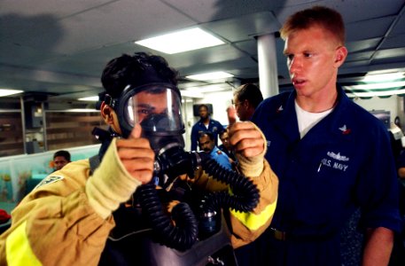 US Navy 020924-N-4309A-031 Damage Controlman 2nd Class Brian Adams assists Pakistani Lt. Affan Anis, assigned to the Tariq-class Pakistani frigate Tippu Sultan (D 185)