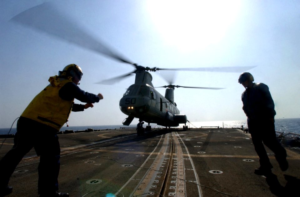 US Navy 021022-N-5471P-049 Supplies are delivered to Mobile Bay by a CH-46 Sea Knight helicopter during flight quarters