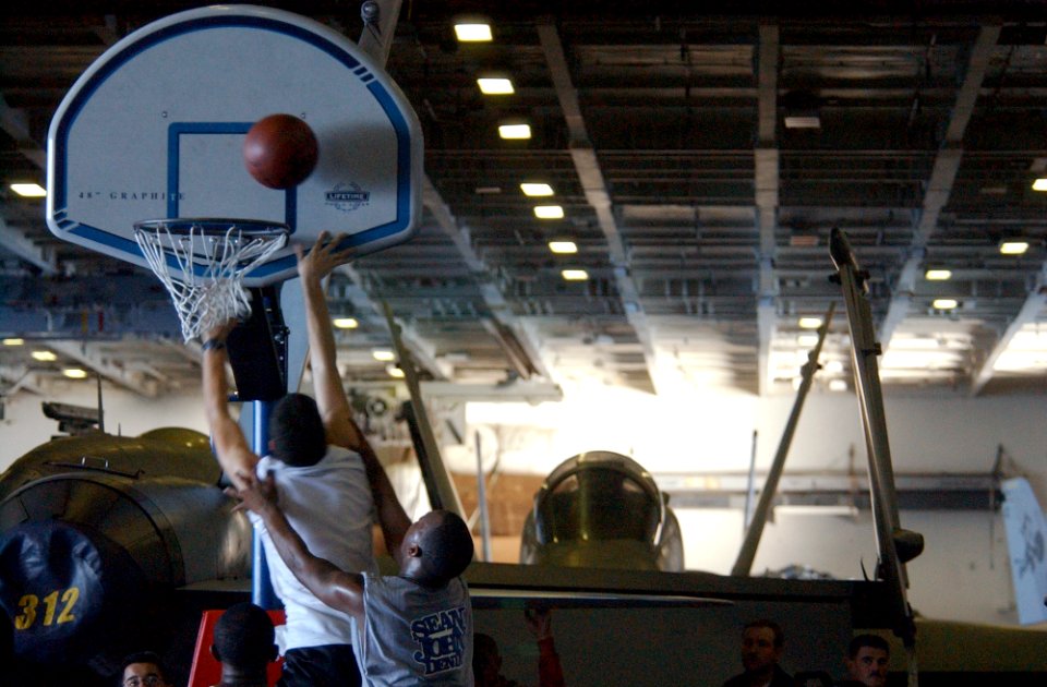 US Navy 021003-N-4309A-008 Crewmembers enjoy a day of playing basketball in the hangar bay during a