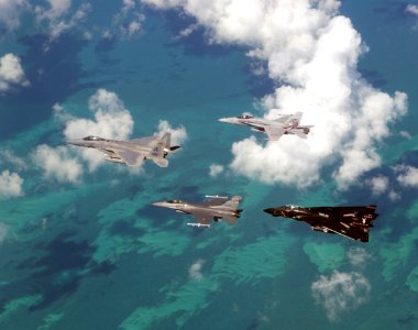 US Navy 021023-F-2034C-020 An Air Force F-15 'Eagle' and F-16 'Falcon' fly in formation with a Navy F-14 'Tomcat' and F-A-18 'Hornet' over the Atlantic Ocean during exercise Cope S
