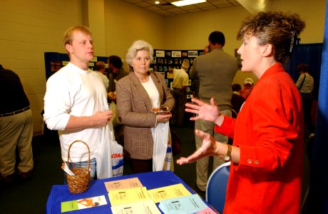 US Navy 021026-N-5862D-006 Robert Yates from Memphis,Tenn., and his mother speak to Lisa Williams from the Fleet Family Support Center to learn what services are available during a visit to Naval Support Activity (NSA) Millingt photo