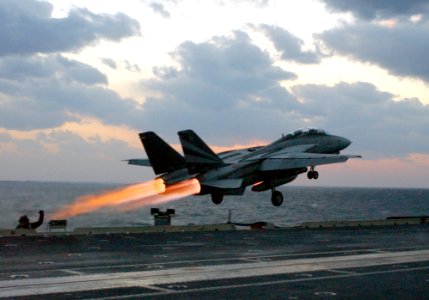 US Navy 021114-N-1810F-018 An F-14 Tomcat assigned to the Black Knights of Fighter Squadron One Five Four (VF-154) launches past steaming catapults on the bow of the ship