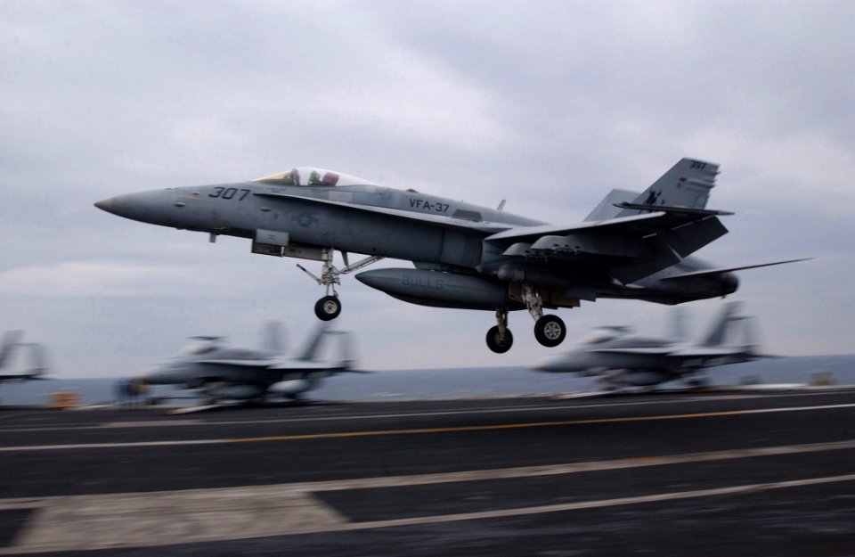 US Navy 021025-N-4953E-003 An F-A 18 'Hornet' assigned to the 'Ragin Bulls' of Strike Fighter Squadron Three Seven (VFA-37), performs a 'touch and go' on the ship's flight deck