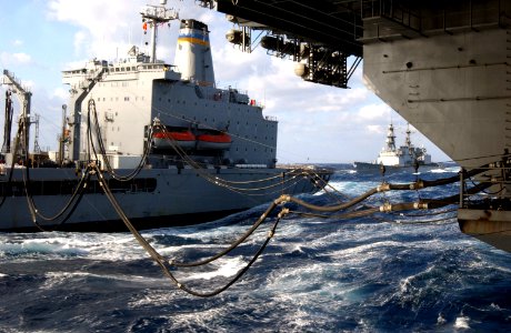 US Navy 021029-N-1810F-001 USS Kitty Hawk (CV 63) receives fuel from the Military Sealift Command (MSC) replenishment oilier USNS Rappahannock (T-AO 204) while the destroyer USS Paul F. Foster (DD 964) approaches from the rear