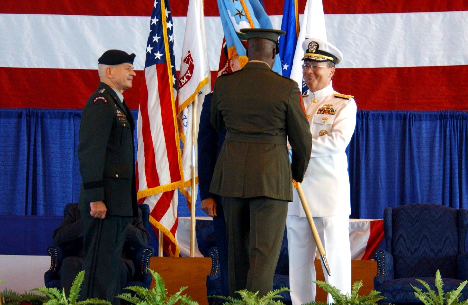 US Navy 021002-N-2383B-527 Admiral Edmund P. Giambastiani, Jr. (right), receives the command flag during a change of command ceremony
