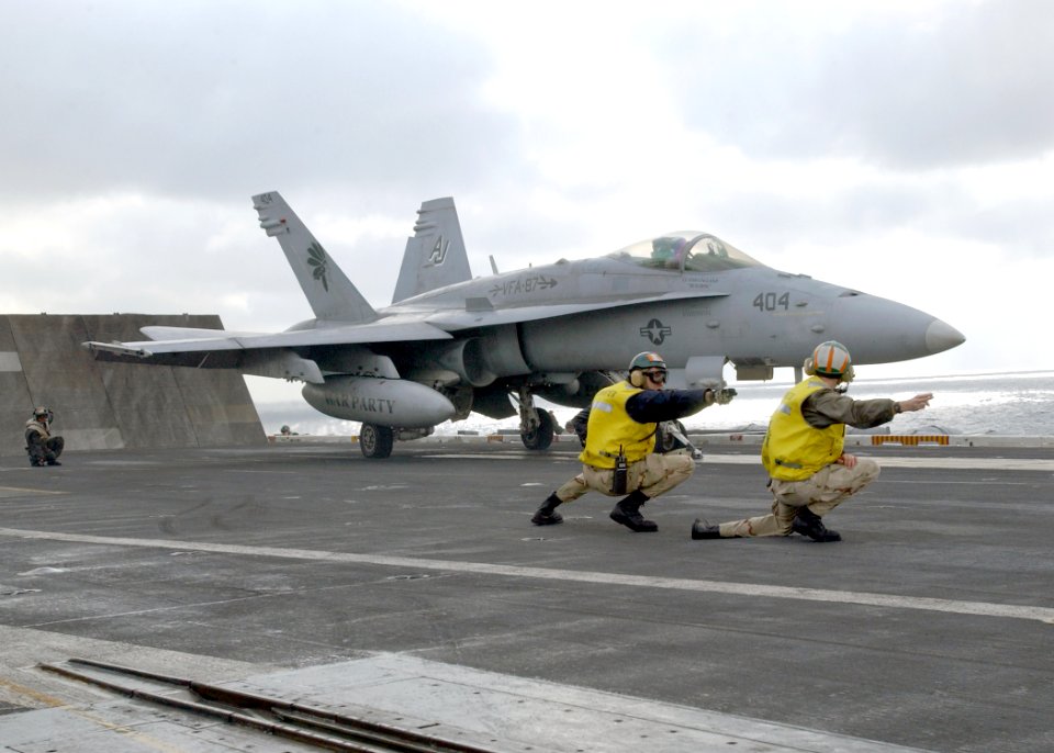 US Navy 021212-N-6895M-501 Flight Deck Officers give an F-A-18 the sign for launch