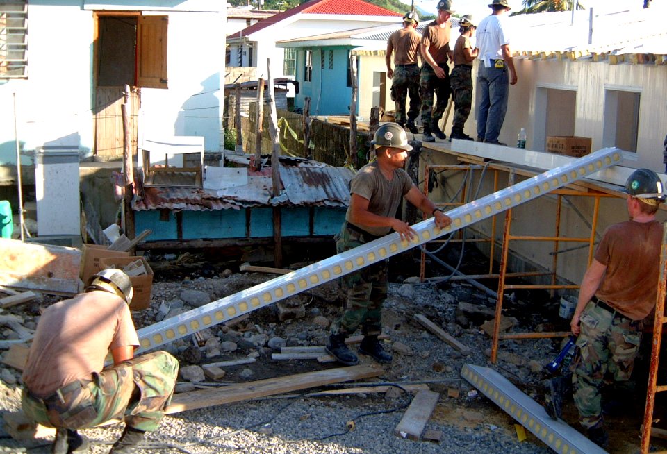 US Navy 021101-N-0507C-011 Seabees put the roof on a 27x47 ft. building that will serve as a civilian medical clinic for the local population of Mahahut, Dominica