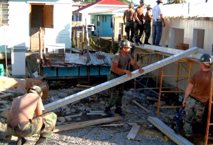 US Navy 021101-N-0507C-011 Seabees put the roof on a 27x47 ft. building that will serve as a civilian medical clinic for the local population of Mahahut, Dominica