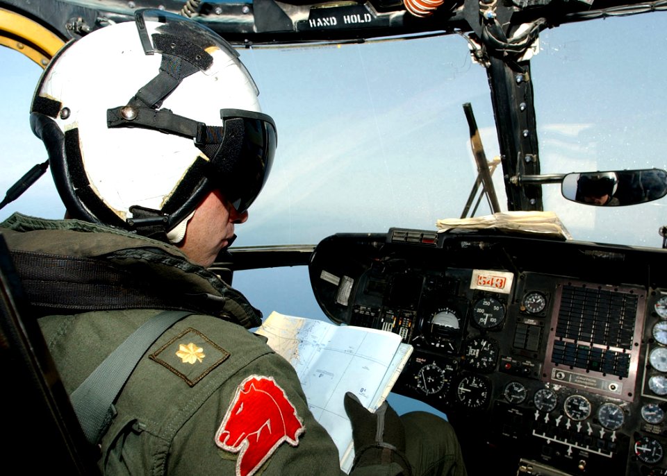 US Navy 020709-N-4374S-011 Pilot checks a navigational chart while flying an MH-53E