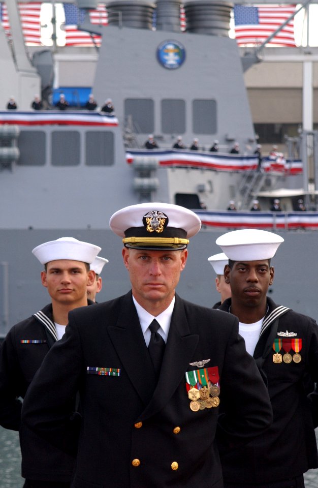 US Navy 021109-N-2383B-698 Lt. Scott Henrickson, center, Fire Controlman 2nd Class Martin Haebeck, left, and Operations Specialist 2nd Class Edison Faggett, stand at parade rest during the guided missile destroyer USS Preble's