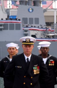 US Navy 021109-N-2383B-698 Lt. Scott Henrickson, center, Fire Controlman 2nd Class Martin Haebeck, left, and Operations Specialist 2nd Class Edison Faggett, stand at parade rest during the guided missile destroyer USS Preble's