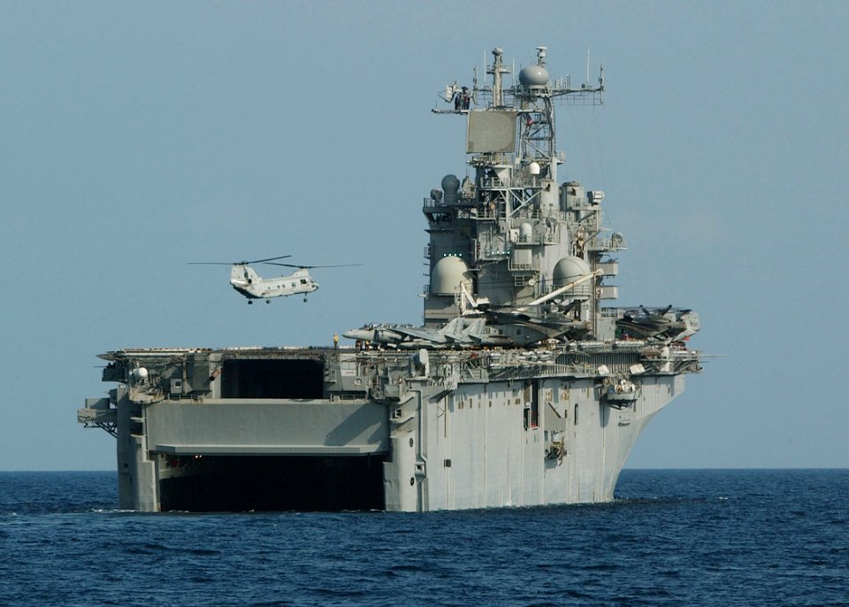 US Navy 021110-N-4374S-058 A CH-46 Sea Knight helicopter hovers over the flight deck of the amphibious assault ship USS Nassau (LHA 4), preparing to land after transporting U.S. Marines from the 24th Marine Expeditionary Unit (