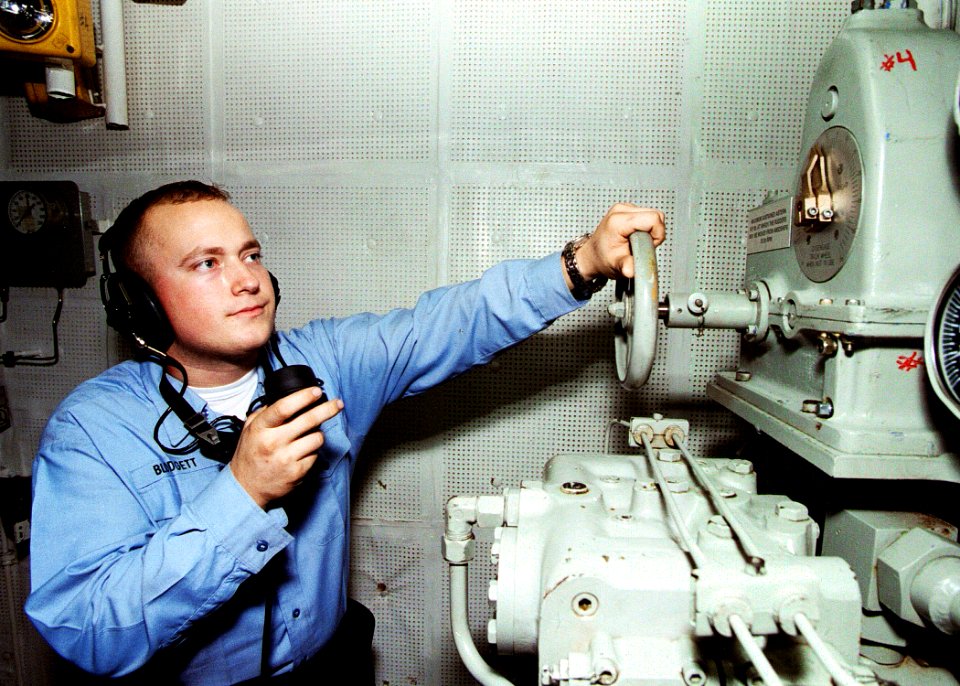 US Navy 030108-N-5786V-001 Fireman Philip Blodgett from Lewistown, Mont., uses sound powered communications to speak with the bridge aboard USS Theodore Roosevelt (CVN 71)