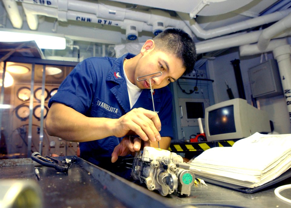 US Navy 020725-N-6268K-001 Sailor conducts maintenance on an part belonging to an F-14 Tomcat aboard ship