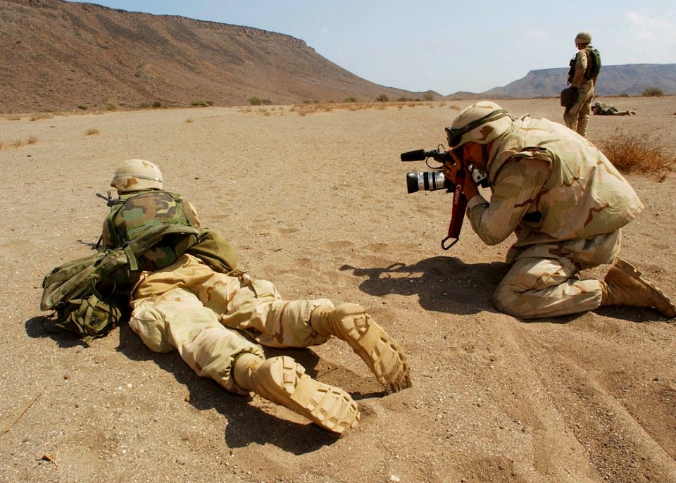US Navy 021112-N-4374S-041 Photographer's Mate 2nd Class Eric Lippmann assigned to Fleet Combat Camera Atlantic, captures video imagery of a U.S. Marine firing an M-16 during a training exercise in Djibouti