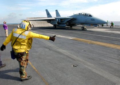 US Navy 021211-N-6895M-503 plane director positions an F-14