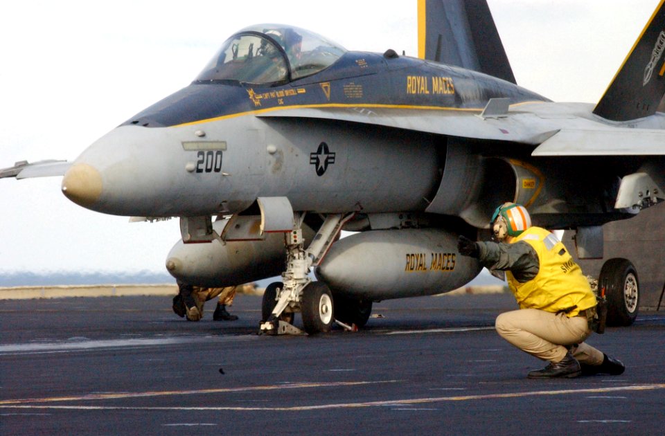 US Navy 021114-N-1810F-006 A 'shooter' launches an F-A-18C 'Hornet' assigned to the 'Royal Maces' of Strike Fighter Squadron Two Seven (VFA-27) from one of four steam driven catapults on the