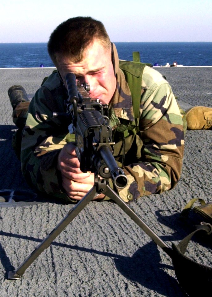 US Navy 030114-N-1512S-005 LCpl Jarret Vaden assigned to the Second Marine Expeditionary Brigade trains on his M-60 machine gun on the ship's flight deck