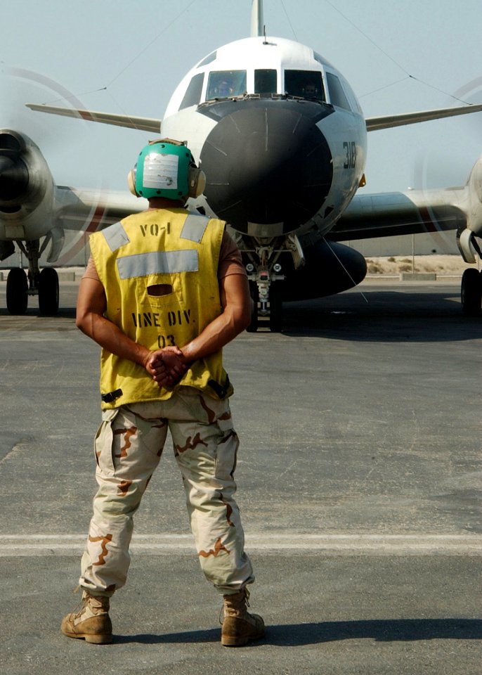 US Navy 021024-N-4374S-038 Plane Captain, Aviation Electronics Technician 3rd Class Timothy Adams, stands by in front of an EP-3E Aries II assigned to the