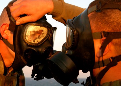 US Navy 030115-N-4048T-027 Marines assigned to the 2nd Marine Expeditionary Brigade home-based at Camp LeJeune, NC., don their gas masks to ensure that they fit properly while training aboard amphibious assault ship